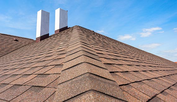 asphalt tile roof with chimney on new home roofing service