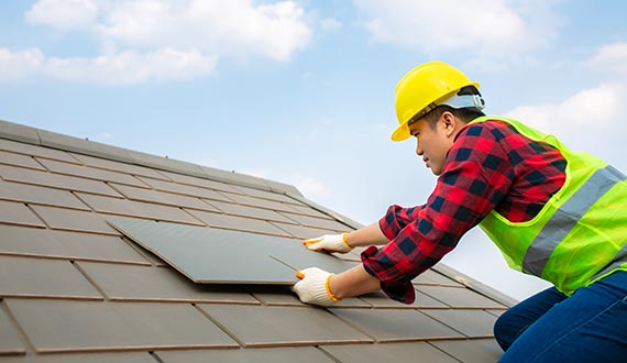 construction worker install and maintenance roof fixing roof tiles on house