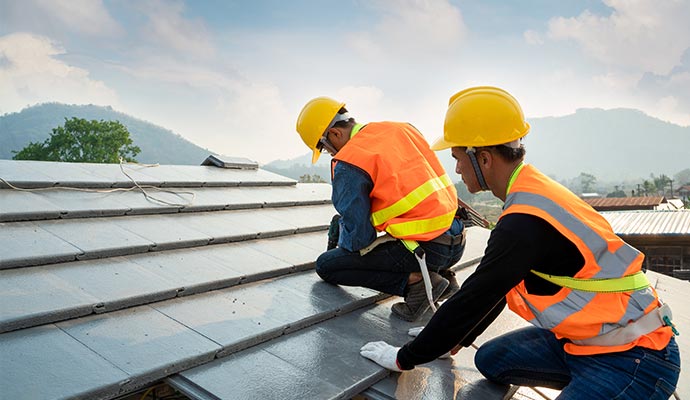 engineers worker install commercial new roof electric drill used