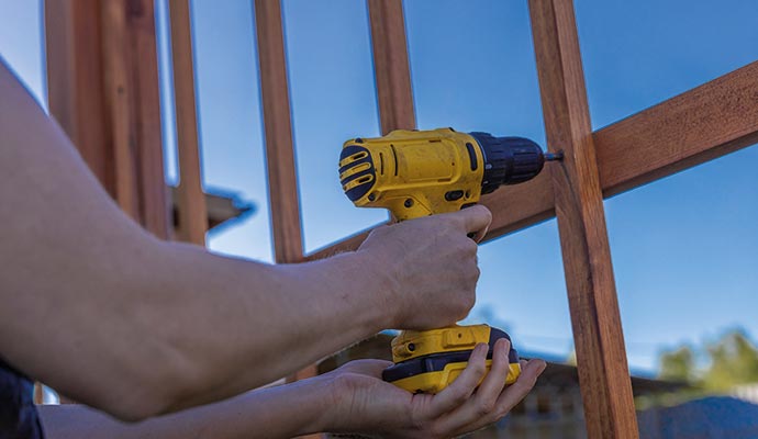 A person is repairing fence