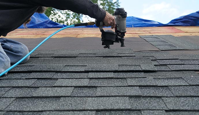 Professional worker installing roof in Round Rock