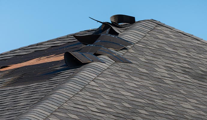 Damaged roof shingles on a residential property