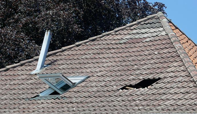 Damaged roof with visible hole Damaged roof with visible hole